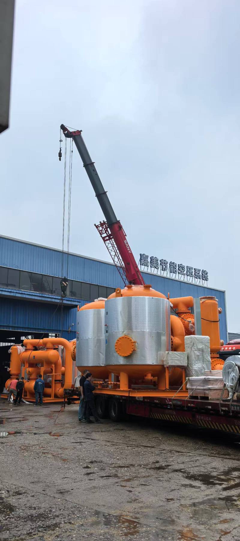 Factory worker assembling machinery on production line